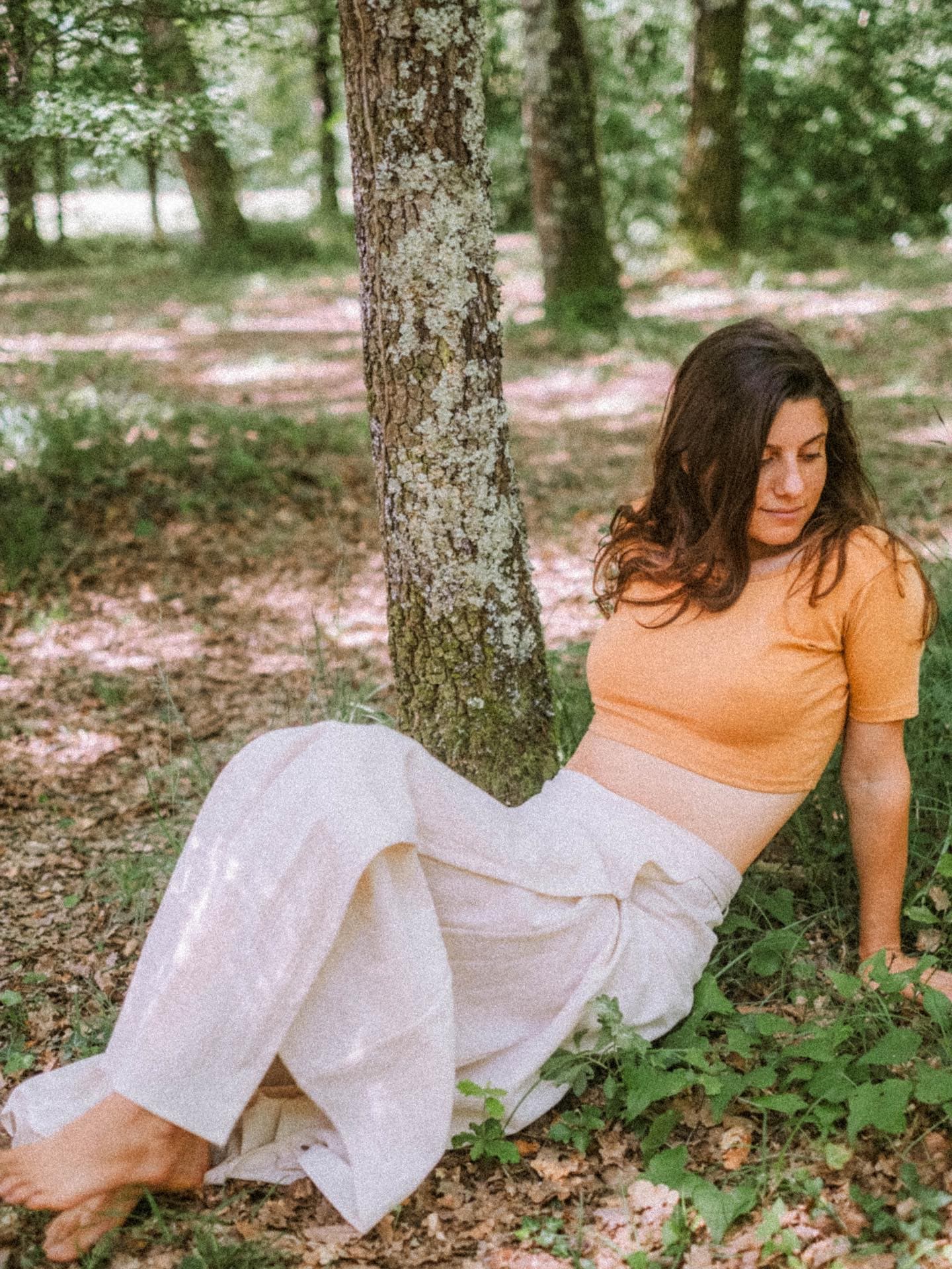 Ana in the forest wearing pieces from the collection